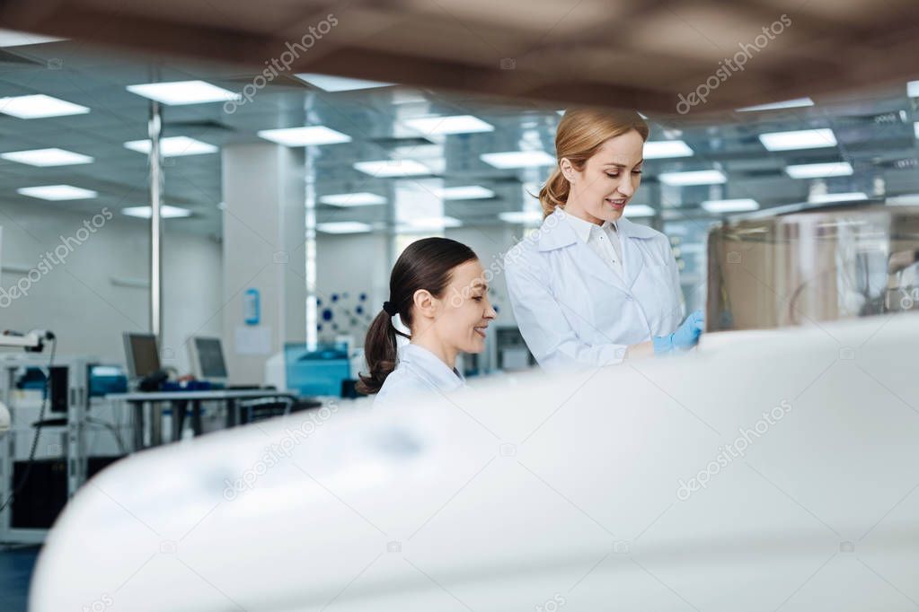 Horizontal photo of positive researchers being in the lab