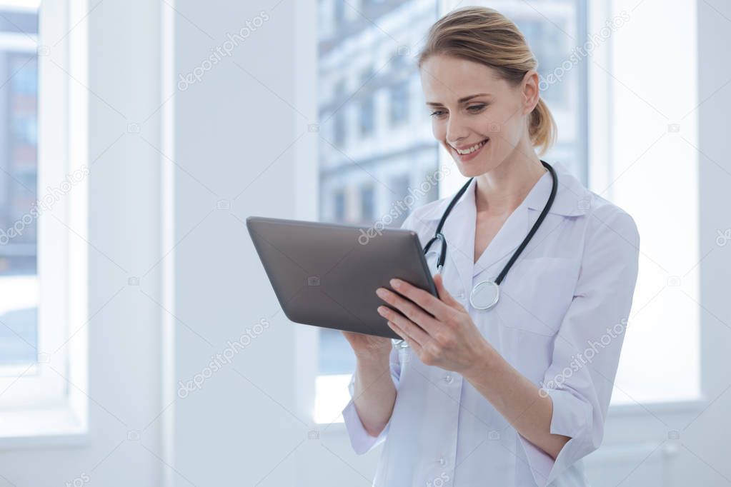 Involved doctor using electronic device in the hospital