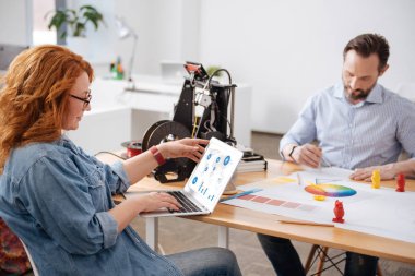 Dizüstü bilgisayar ekranına bakarak keyifli memnun kadın