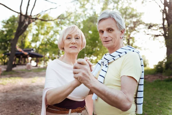 Charismatic pensioners dancing in the park