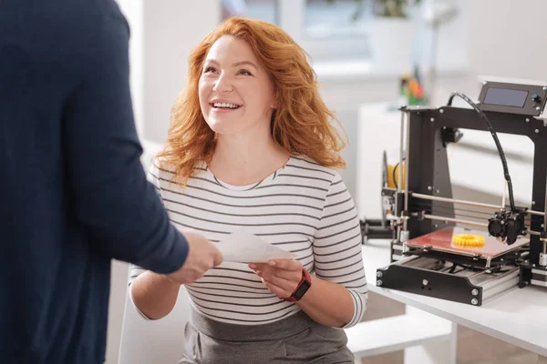 Pleasant good looking woman taking a document — Stock Photo, Image