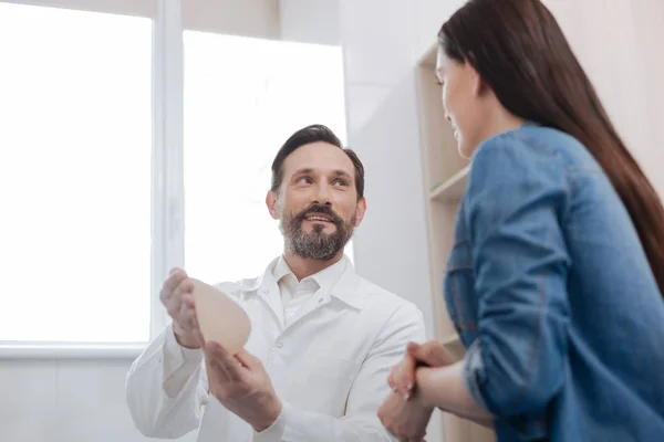 Private plastic surgeon showing the materials he working with — Stock Photo, Image