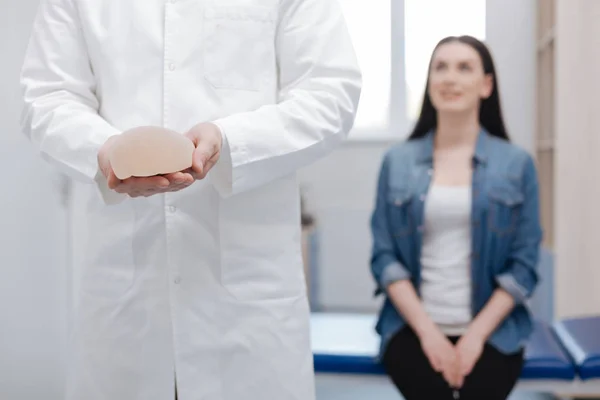 Doctor receiving a visit from young lady — Stock Photo, Image