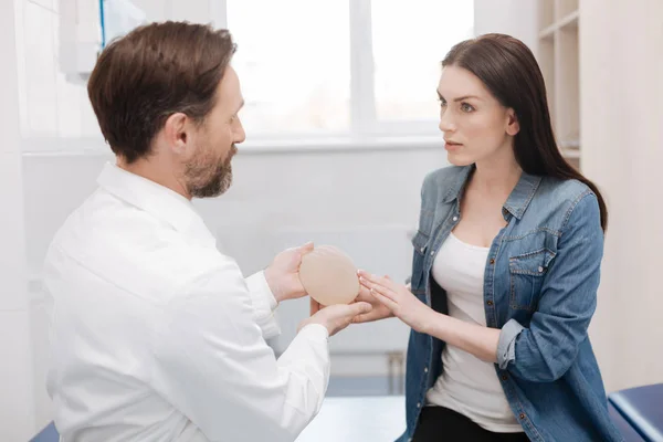 Wise admirable woman asking about details of plastic surgery — Stock Photo, Image