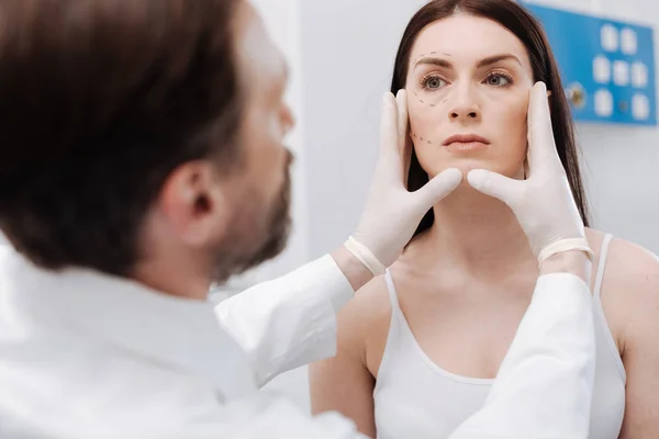 Professional plastic surgeon defining the volume of work — Stock Photo, Image