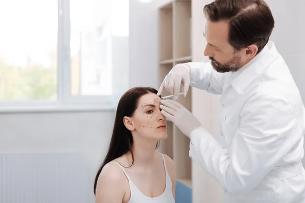 Motivated elegant lady visiting beautician for special procedure — Stock Photo, Image