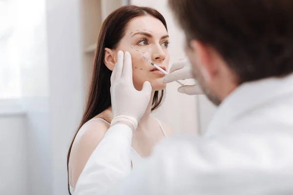 Delicate careful beautician minimizing the signs of age — Stock Photo, Image