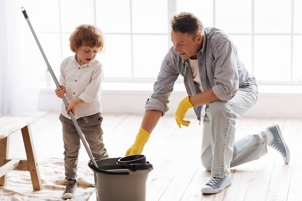 Serious male person controlling his son