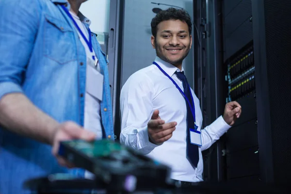 Delighted positive technician looking at the rack server