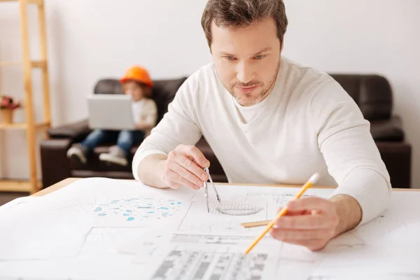 Serious engineer using special stationery — Stock Photo, Image