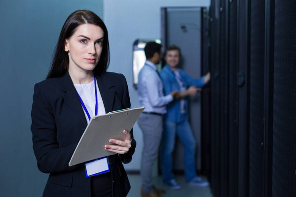 Serious beautiful woman holding notes