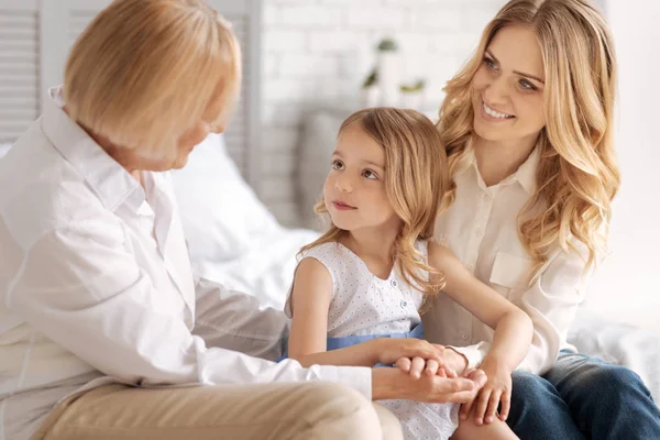 Cute little girl socializing with her pleasant grandmother — Stock Photo, Image
