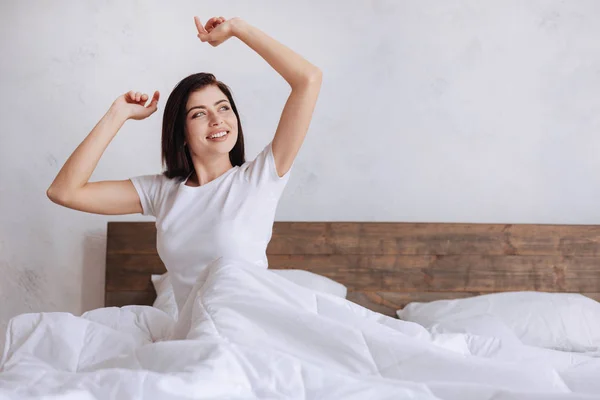 woman waking up with arms outstretched