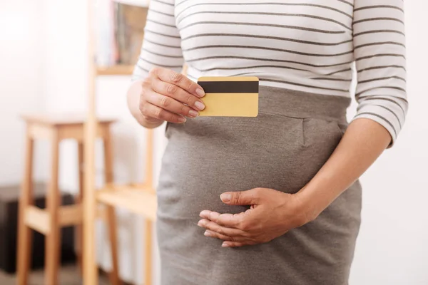 Nice pregnant woman holding a credit card — Stock Photo, Image