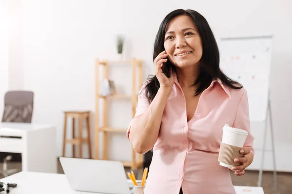 Nice pregnant woman talking on phone in the office — Stock Photo, Image