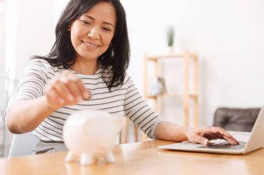 Kumbara para koyarak olumlu Asyalı kadın