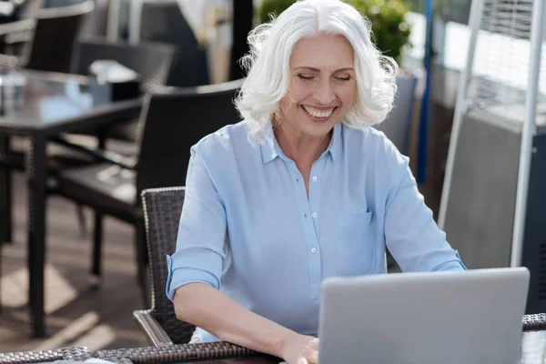 Positive delighted woman working with laptop — Stock Photo, Image