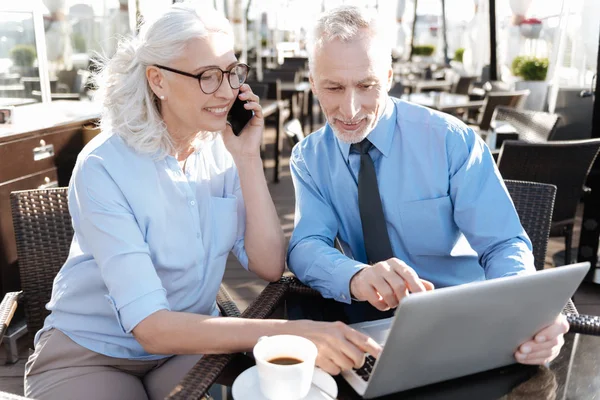 Positive delighted businesswoman helping her partner — Stock Photo, Image