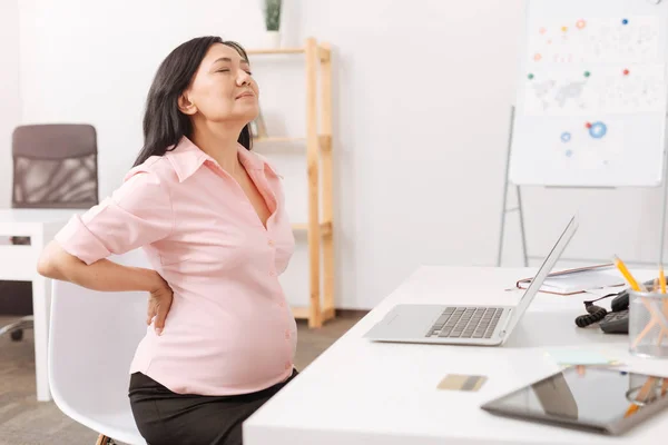 Tired pregnant woman having a backache — Stock Photo, Image