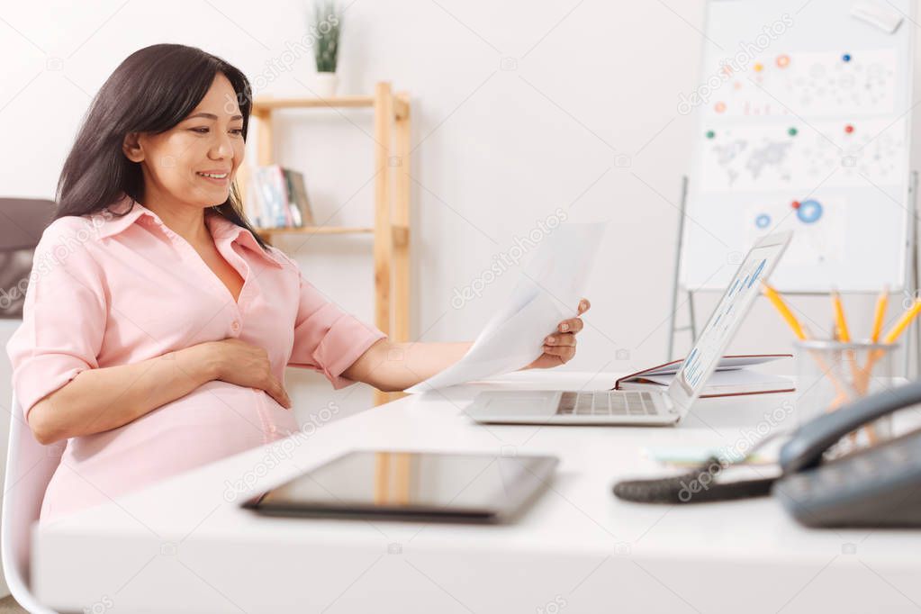 Positive pregnant woman working