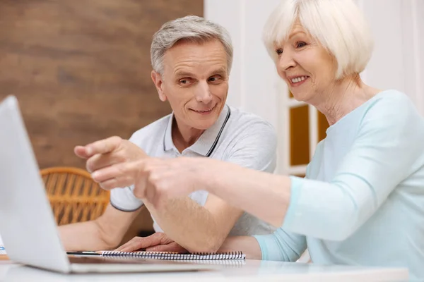 Cute elderly couple discussing details of the project — Stock Photo, Image