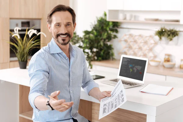 Pleasant cheerful man holding a printout — Stock Photo, Image