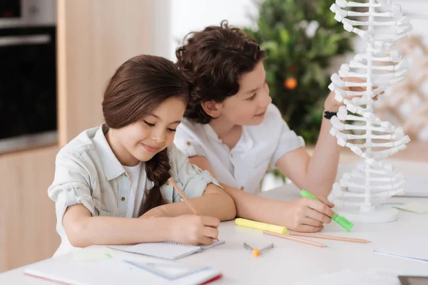 Little brother and sister working on a biology project — Stock Photo, Image