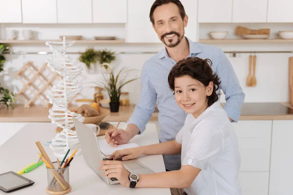 Charming son and his father doing a school project together — Stock Photo, Image