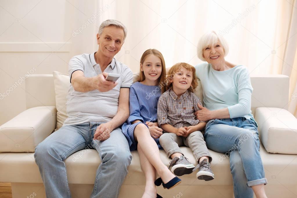 Positive vibrant family watching a movie together