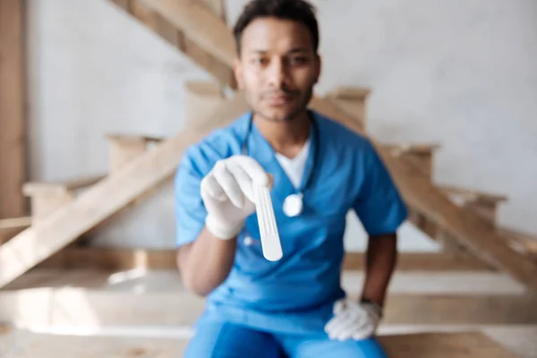 Horizontal photo of serious doctor that holding special instrument — Stock Photo, Image