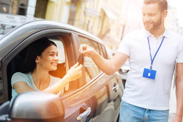 Auto pronájem agentura zaměstnanec dát klíče od auta k ženě — Stock fotografie