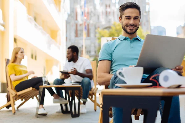 Lovely creative guy enjoying working outdoors — Stock Photo, Image