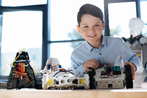 Joyful boy showing newly created robotic car — Stock Photo, Image