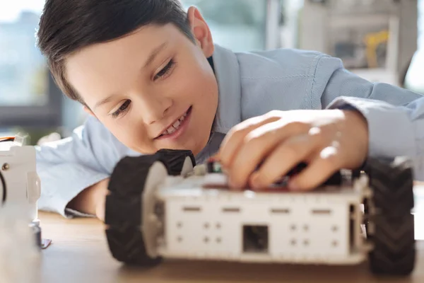 Detailní záběr roztomilé chlapce dotýká model robotického auta — Stock fotografie