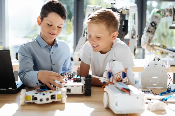 Pleasant little kids creating robots together — Stock Photo, Image