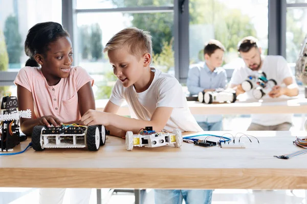 Αγόρι και κορίτσι που συζητάμε για την κατασκευή ενός ρομποτικού αυτοκινήτου — Φωτογραφία Αρχείου