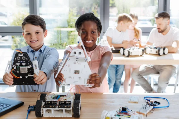 Best friends showing their robot models — Stock Photo, Image