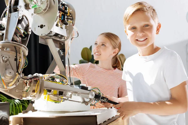 Upbeat little kids visiting robotics exhibition — Stock Photo, Image