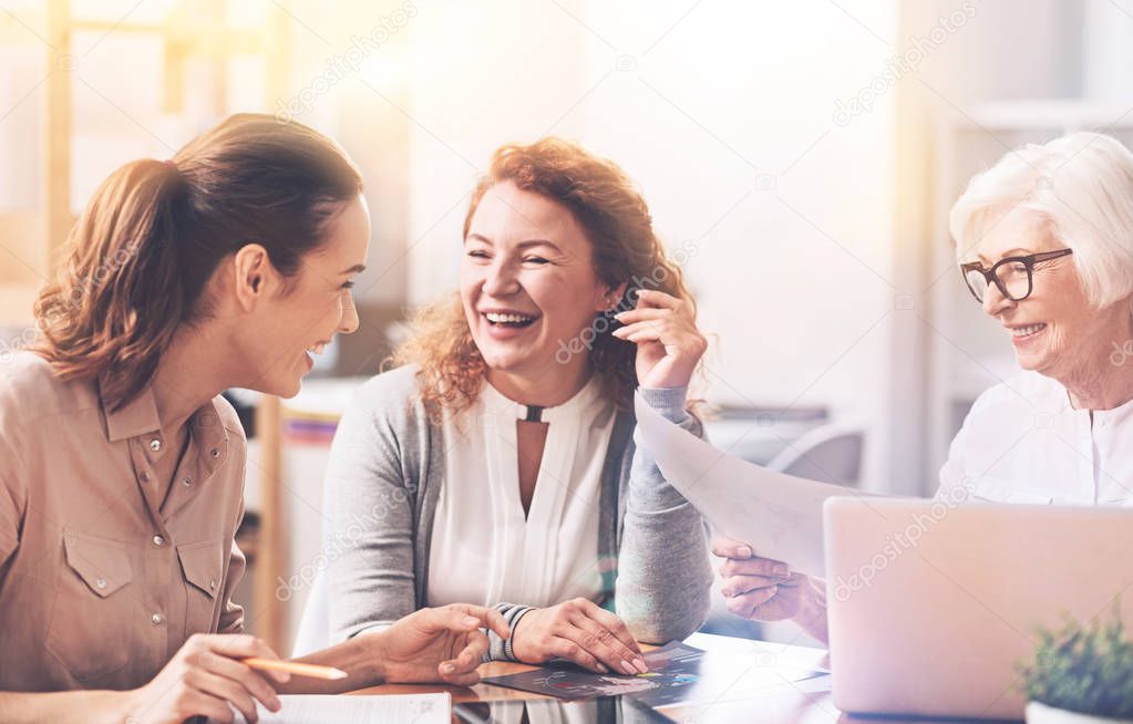 Emotional passionate colleagues laughing at joke