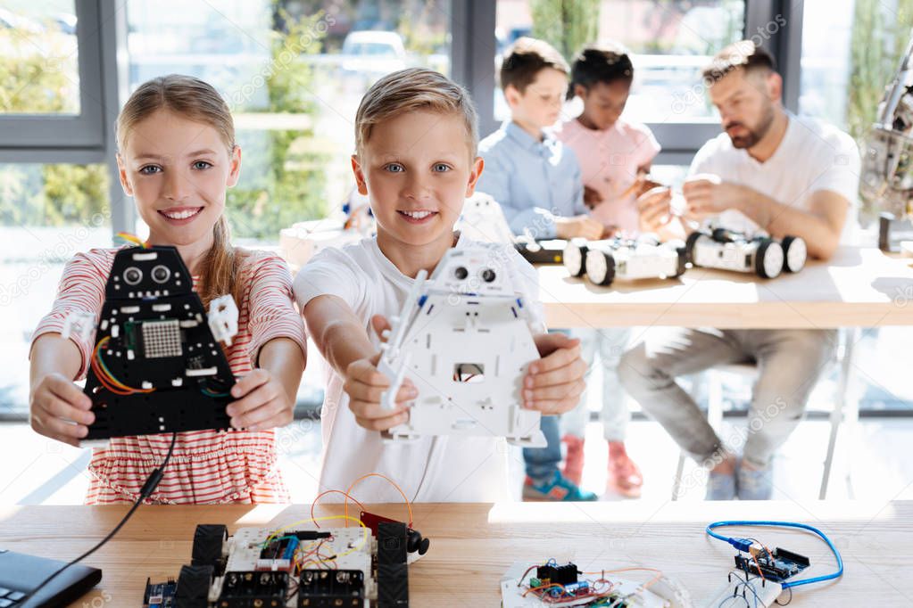 Sister and brother holding their robot models