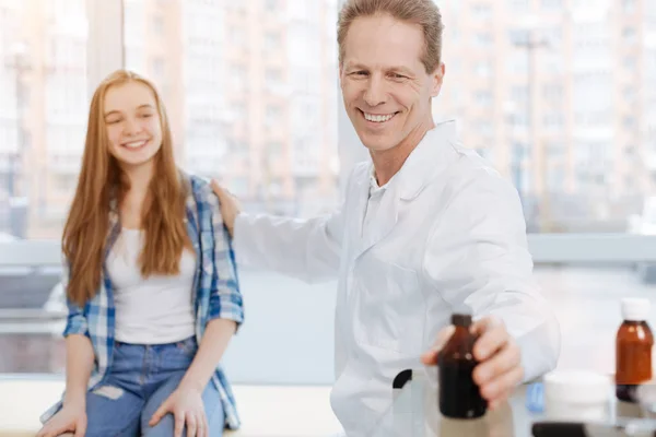 Optimistic doctor enjoying working hours in the clinic — Stock Photo, Image