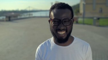 Yaygın olarak kamera için poz sırıtarak neşeli Afrikalı-Amerikalı adam