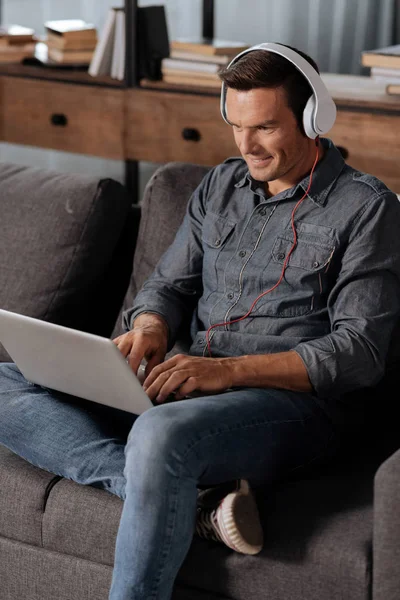 Motivierter netter Mann, der während der Arbeit grübelnd zuhört — Stockfoto