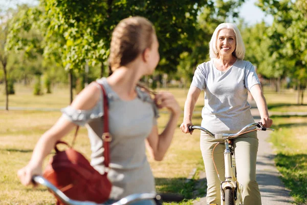 Woman riding a bicycle with  granddaughter — Stock Photo, Image