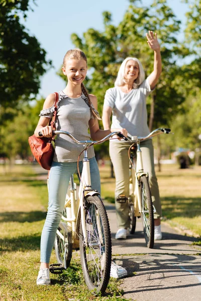 Girl riding a bicycle with her grandma — Stock Photo, Image