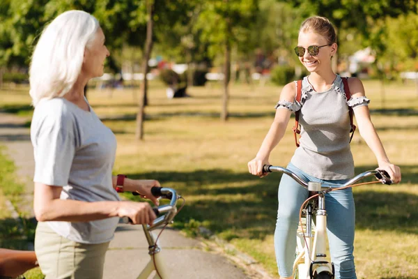 Girl  riding bicycle with her grandmother — Stock Photo, Image