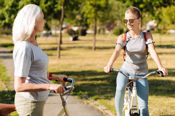 girl  riding bicycle with her grandmother