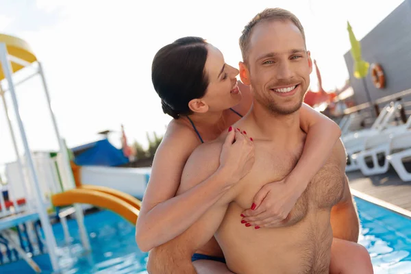 Joyful woman being about to bite her husbands ear — Stock Photo, Image