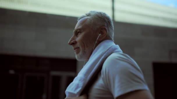 スポーツ トレーニングの後を歩いて喜んでの年配の男性 — ストック動画