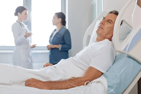 Agradable hombre de mediana edad descansando en su cama — Foto de Stock